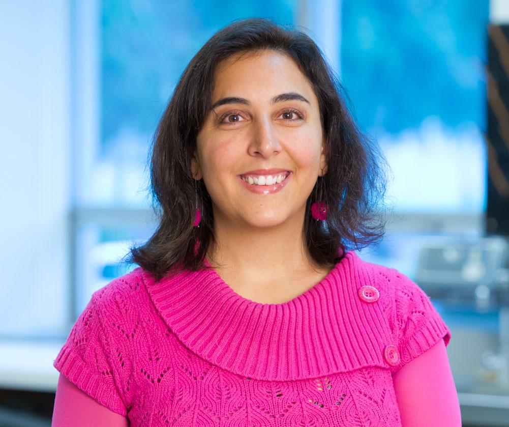 Macarena in a pink sweater and blue background